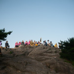A bunch of people meditating at one of the highest spots at Yellow Mountain.