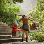 This man is carrying raw meat and some other goods on the left side. On the right side he is carrying eggs and vegetables. At a higher resolution you can see individual sweat beads on his back. There were tons of men carrying things up the mountain like this. Some men were carrying cases of water, jugs of oil and other food items. The majority of the men doing this looked to be over 40-years-old. I suppose they could've aged more quickly if that was their career, but I'm not sure that is the case.