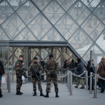 Men with machine guns guard a gigantic glass triangle. Inside nuclear art emits a captivating force of radiation on various humans who unthinkingly digest a prescribed culture.