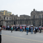 A Peruvian guy walking pauses and contemplates the reverse zoo that happens every morning. He wonders if this tourist influx is really worth its impact on the GDP.