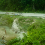 A group of boys bathing or playing in a little stream.