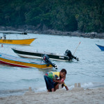 Are these kids making sand castles or Coca Cola advertisements?! Notice the boat behind them called "Angry Bird".