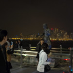 A Bruce Lee-alike stands in karate pose, painted in iron to mimic a statue, while thousands of visitors take their picture to later show their kids how they went to a spot specifically designed to unthinkingly take pictures in front of... and then they took pictures in front of it. Good memories...