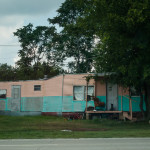 A pup keeps his ear out for intruders. His owner's mobile home was rated "Best Completely Standing Two-Tone Pseudo-Home in a 30-Mile Radius of Russsellville".