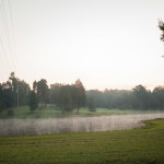 Steam rising off the water of a hillbilly pond. No yokels in sight, still too early for them to get up and neglect their unreasonable number of uncivilized captive dogs.