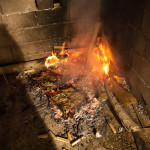 Too poor for a grill, our hosts just threw the meat on the ground. I didn't really care if it burned or not, or about this picture, my shadow is only there because it was fucking cold outside.